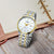 Herren-Armbanduhr mit weißem Zifferblatt und Edelstahlband in Gold-/Silberoptik