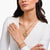 Złoty łańcuszek z ogniw z okrągłym spiralnym detalem przy zawieszce, na szyi
